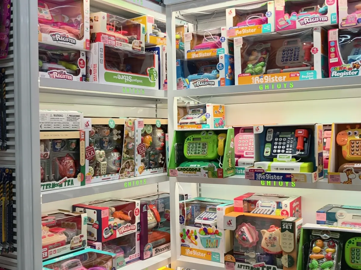 Electronic and novelty toys including toy cash registers on a showroom shelf