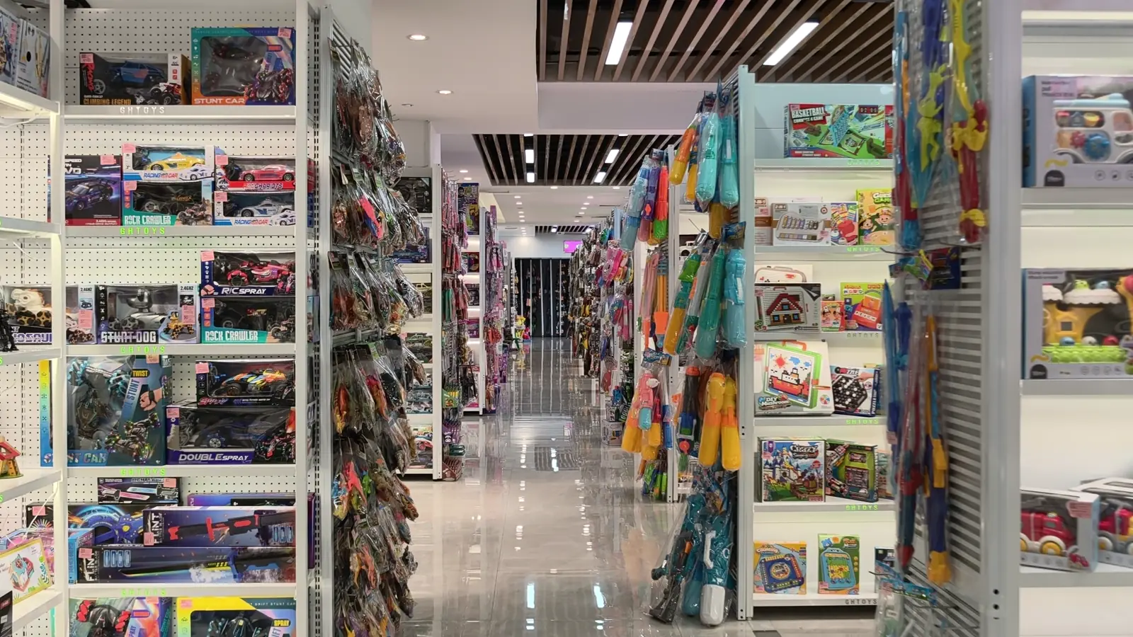 Long aisle of toy shelves inside a Shantou showroom